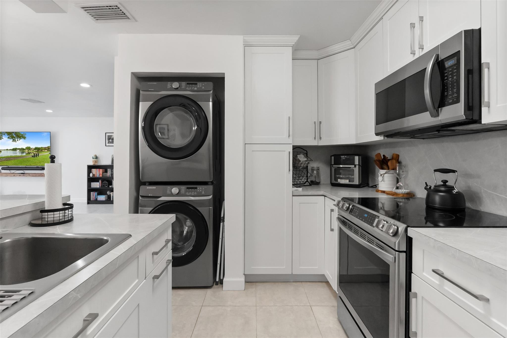 13278 Southwest 114th Terrace, Unit 13278 Miami, FL 33186 - Photo 4 of 35 a kitchen with a stove top oven and sink