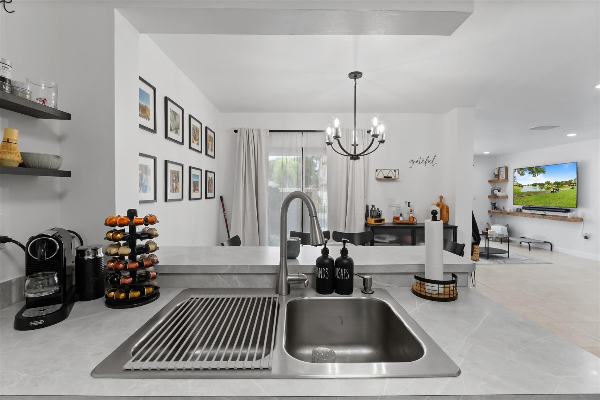 13278 Southwest 114th Terrace, Unit 13278 Miami, FL 33186 - Photo 5 of 35 a kitchen with sink a faucet and chairs