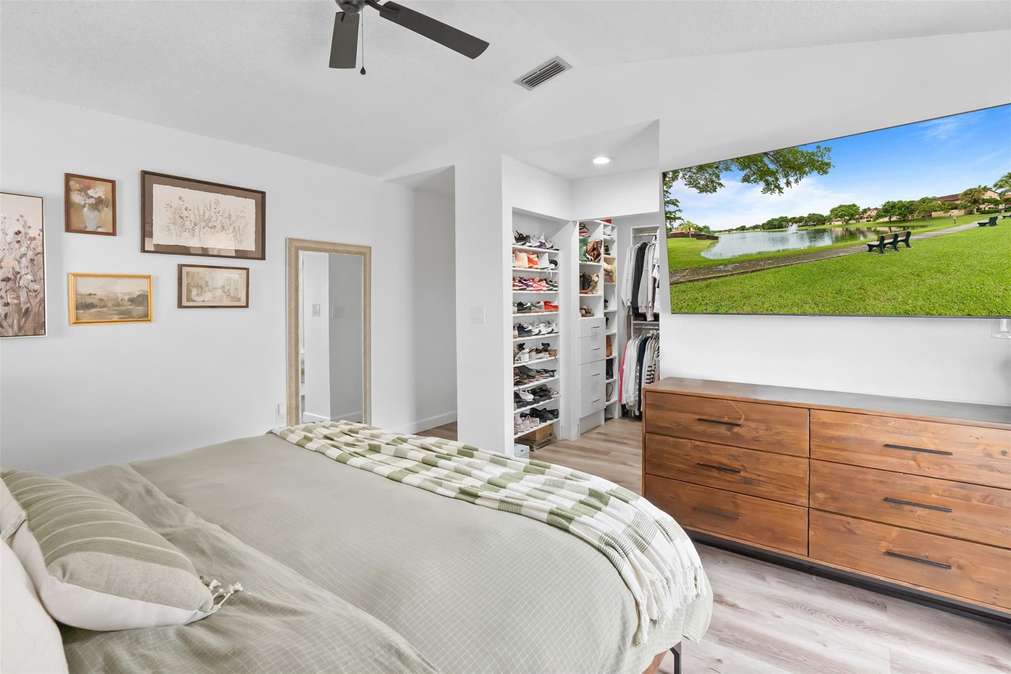 13278 Southwest 114th Terrace, Unit 13278 Miami, FL 33186 - Photo 9 of 35 a bedroom with a bed a dresser and a large mirror