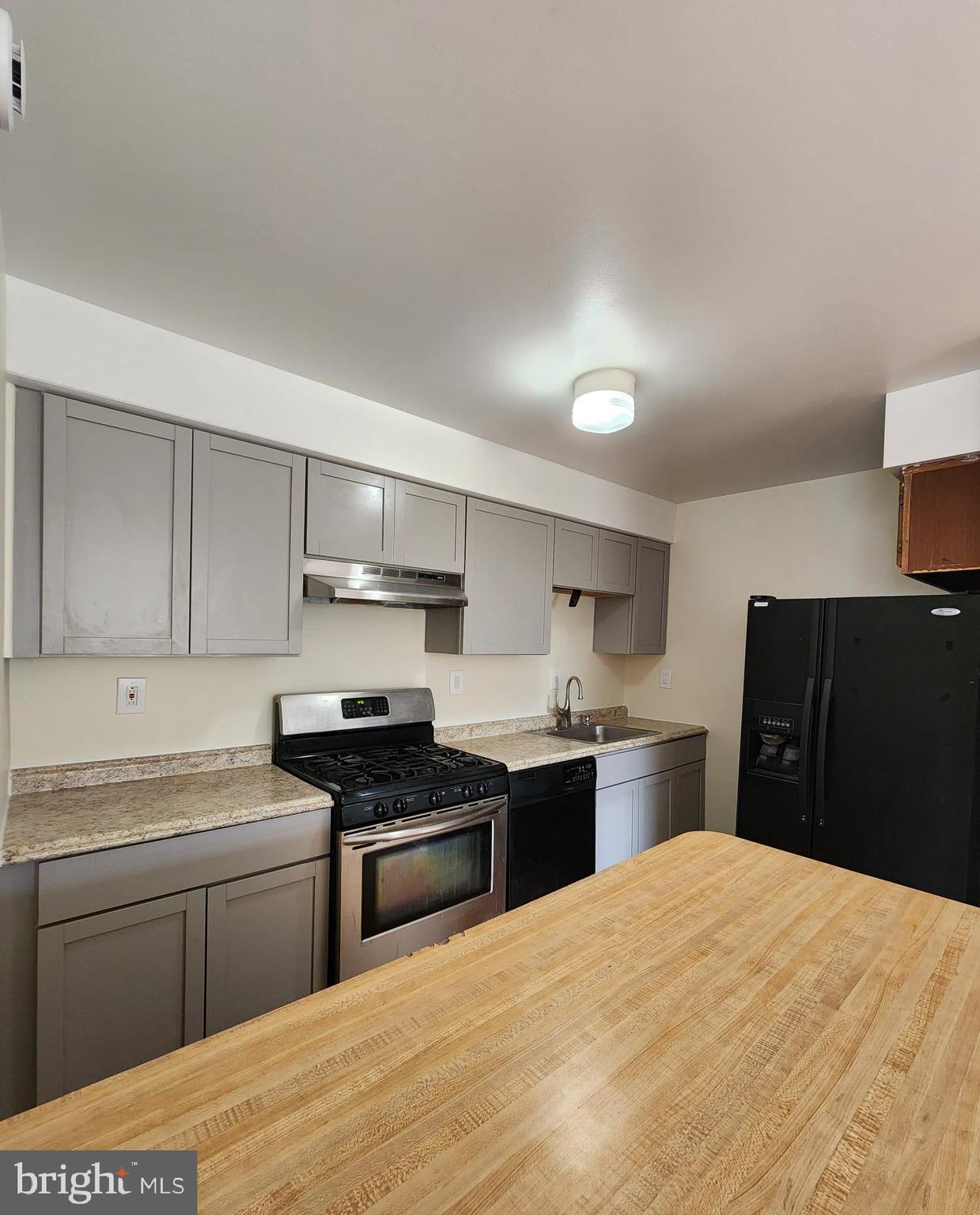 157 Meadowbrook Lane, Unit 2 Brookhaven, PA 19015 - Photo 1 of 13 a kitchen with a refrigerator stove top oven and sink