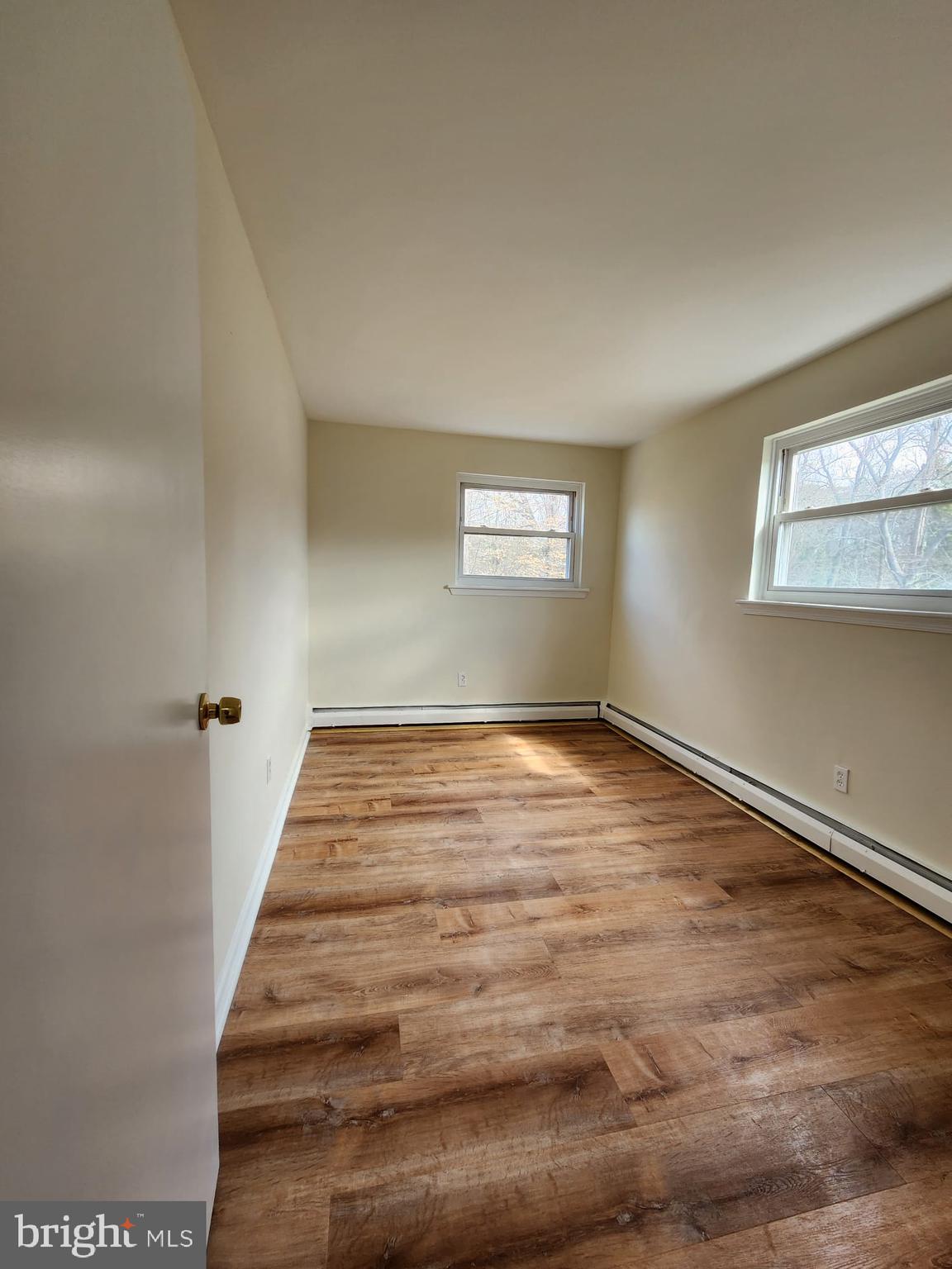 157 Meadowbrook Lane, Unit 2 Brookhaven, PA 19015 - Photo 12 of 13 a view of a room with wooden floor and window