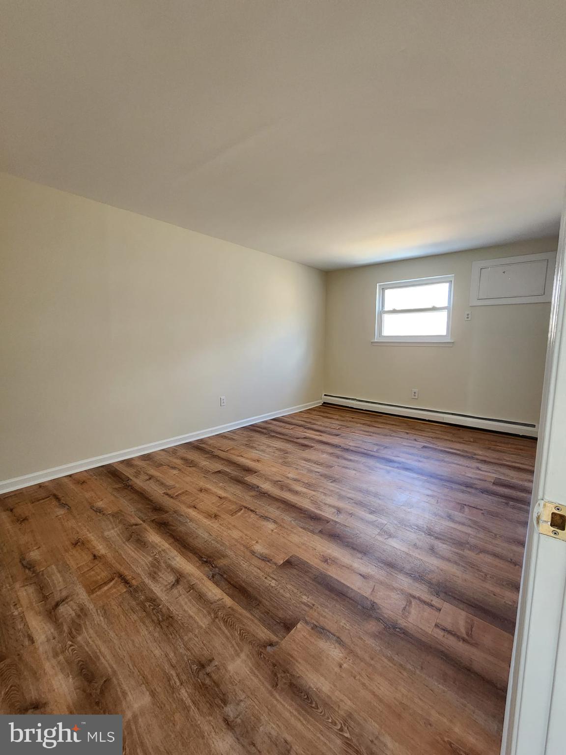 157 Meadowbrook Lane, Unit 2 Brookhaven, PA 19015 - Photo 4 of 13 a view of empty room with wooden floor
