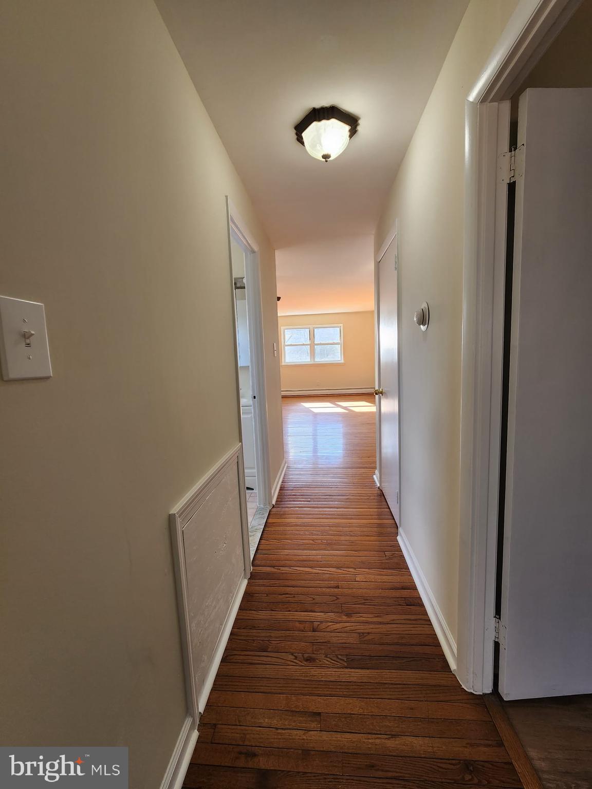157 Meadowbrook Lane, Unit 2 Brookhaven, PA 19015 - Photo 6 of 13 a view of a hallway with wooden floor