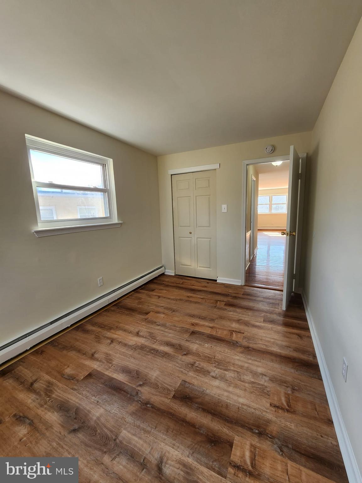 157 Meadowbrook Lane, Unit 2 Brookhaven, PA 19015 - Photo 8 of 13 a view of empty room with wooden floor