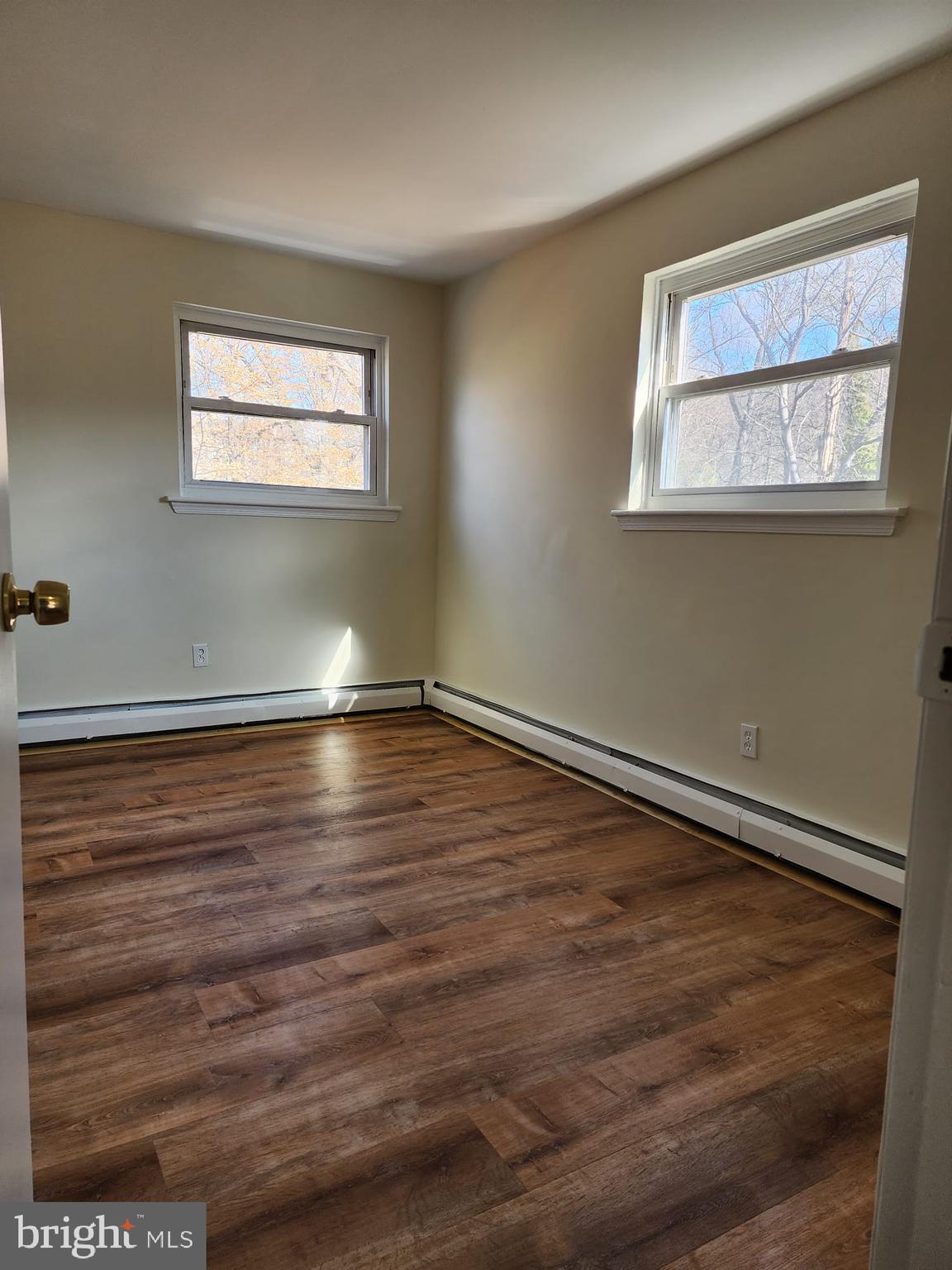 157 Meadowbrook Lane, Unit 2 Brookhaven, PA 19015 - Photo 9 of 13 a view of room with window and wooden floor
