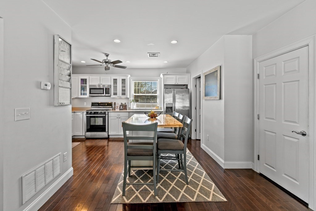 651 Nashua Road Dracut, MA 01826 - Photo 12 of 42 a living room with stainless steel appliances furniture a rug and a kitchen view