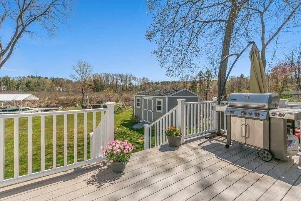 651 Nashua Road Dracut, MA 01826 - Photo 17 of 42 a view of a balcony with wooden floor and fence