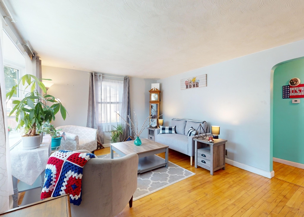 1205 Trapelo Road Waltham, MA 02451 - Photo 3 of 25 a living room with furniture a rug and a potted plant