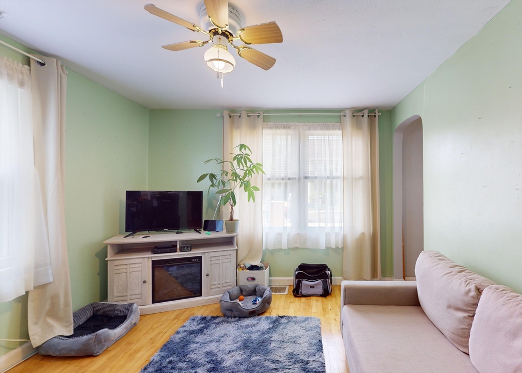1205 Trapelo Road Waltham, MA 02451 - Photo 6 of 25 a living room with furniture a flat screen tv and a fireplace