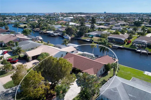an aerial view of a houses with a lake view