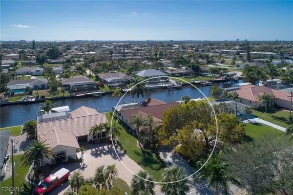 an aerial view of a house with outdoor space lake view and boat