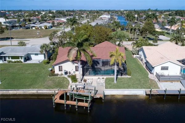 an aerial view of residential houses with outdoor space and parking