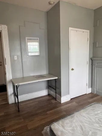 a view of room with window and wooden floor