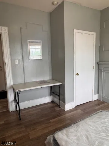 a view of room with window and wooden floor