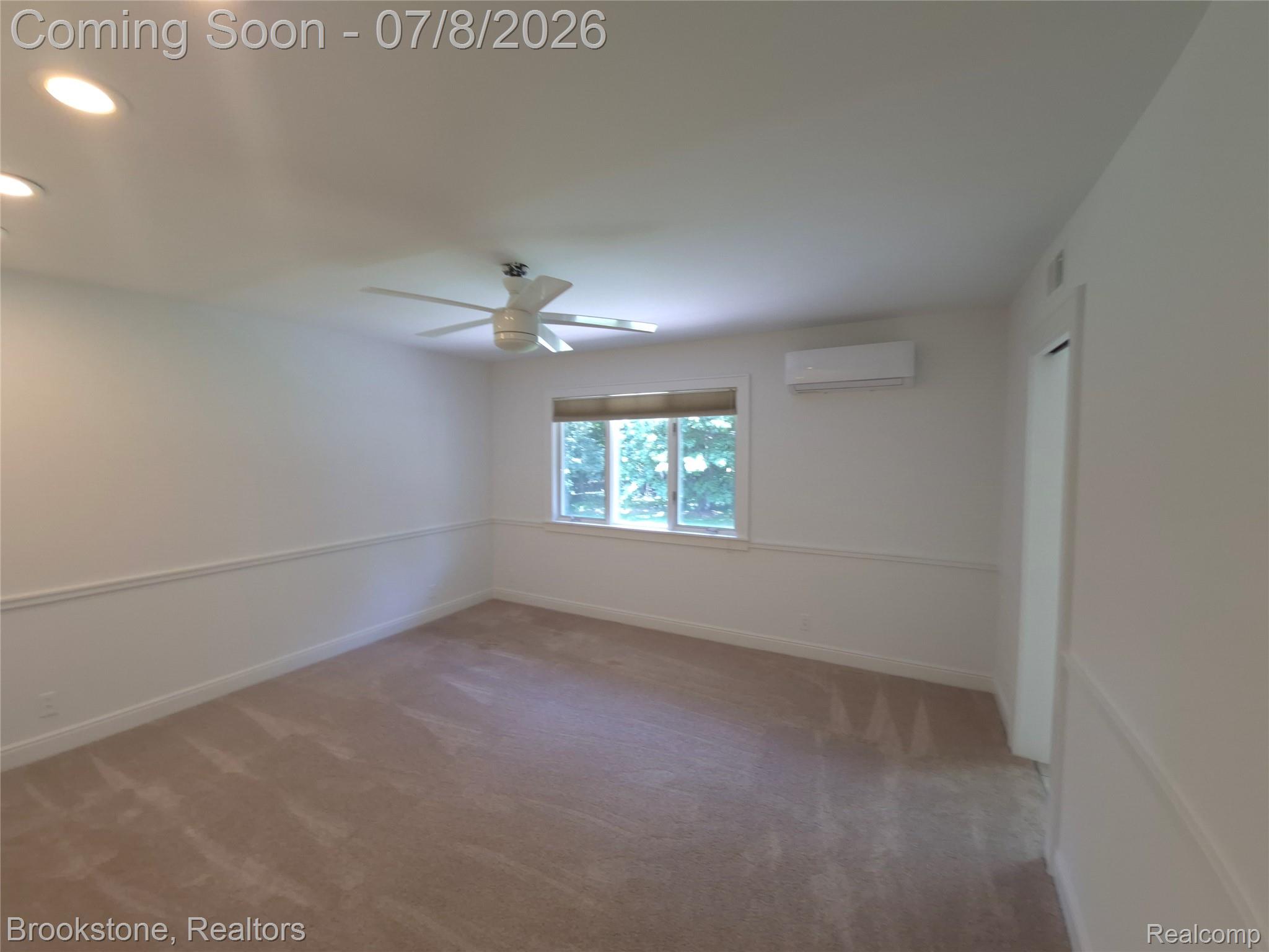 4140 South Henderson Road Davison, MI 48423 - Photo 64 of 98 Carpeted room with white walls, chair rail molding, and a window