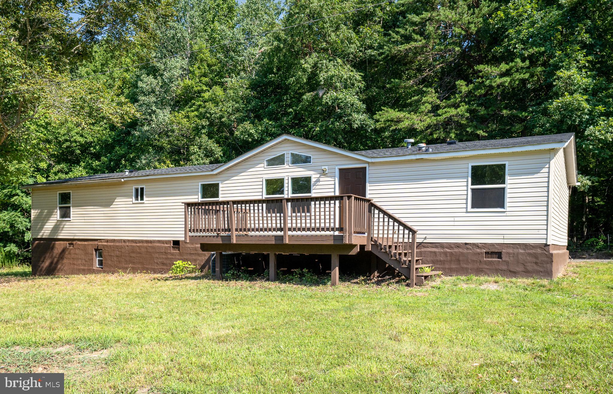185 Deane Road Louisa, VA 23093 - Photo 1 of 42 a view of a house with a wooden deck and a yard