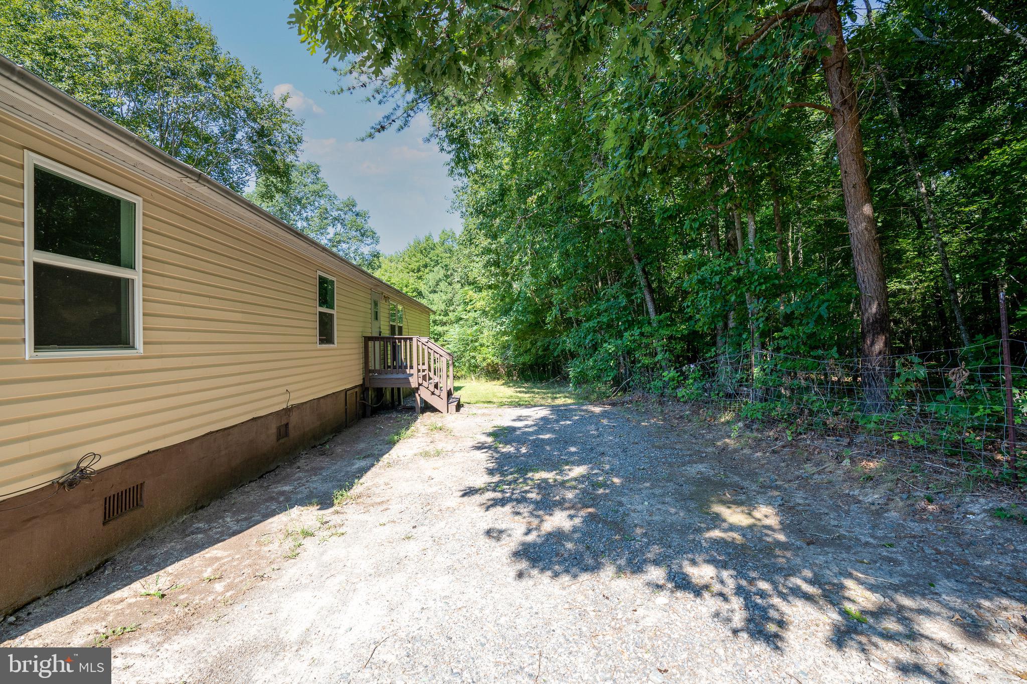 185 Deane Road Louisa, VA 23093 - Photo 2 of 42 a view of a back yard of the house