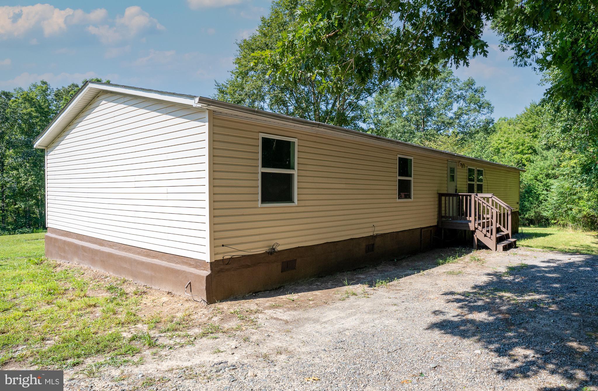 185 Deane Road Louisa, VA 23093 - Photo 13 of 42 a view of a house with a yard and wooden fence
