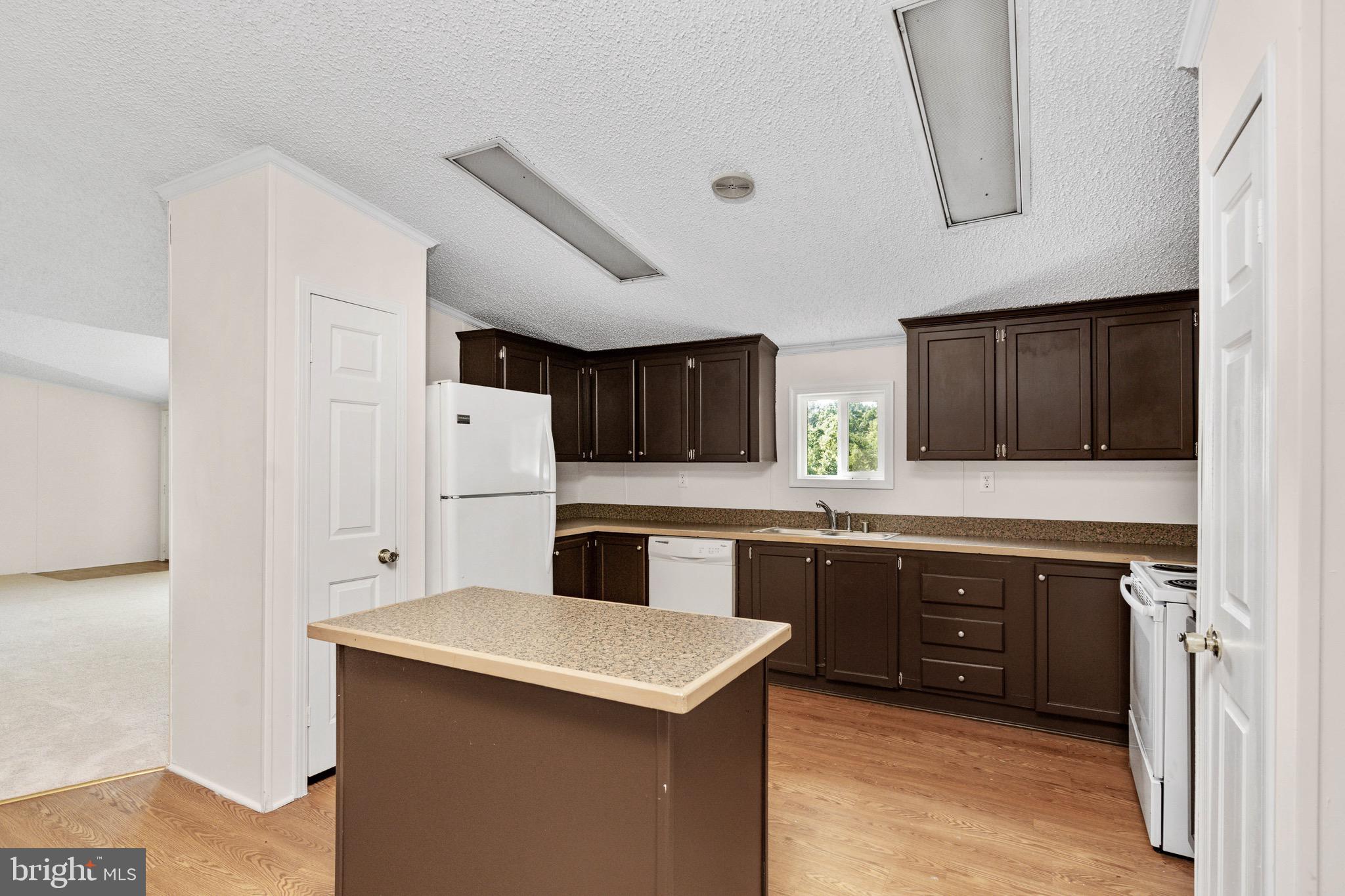185 Deane Road Louisa, VA 23093 - Photo 22 of 42 a kitchen with a sink a stove a refrigerator and cabinets