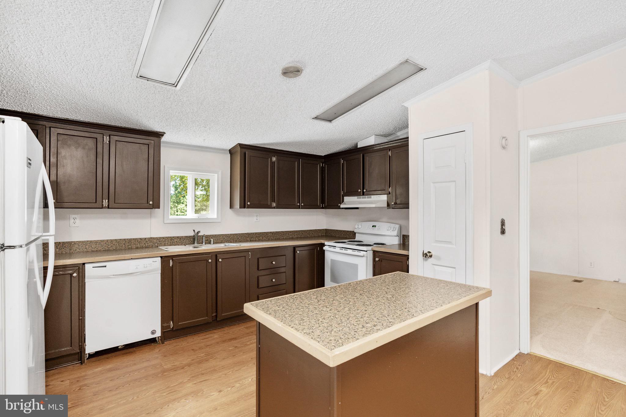 185 Deane Road Louisa, VA 23093 - Photo 23 of 42 a kitchen with stainless steel appliances granite countertop a sink stove and refrigerator