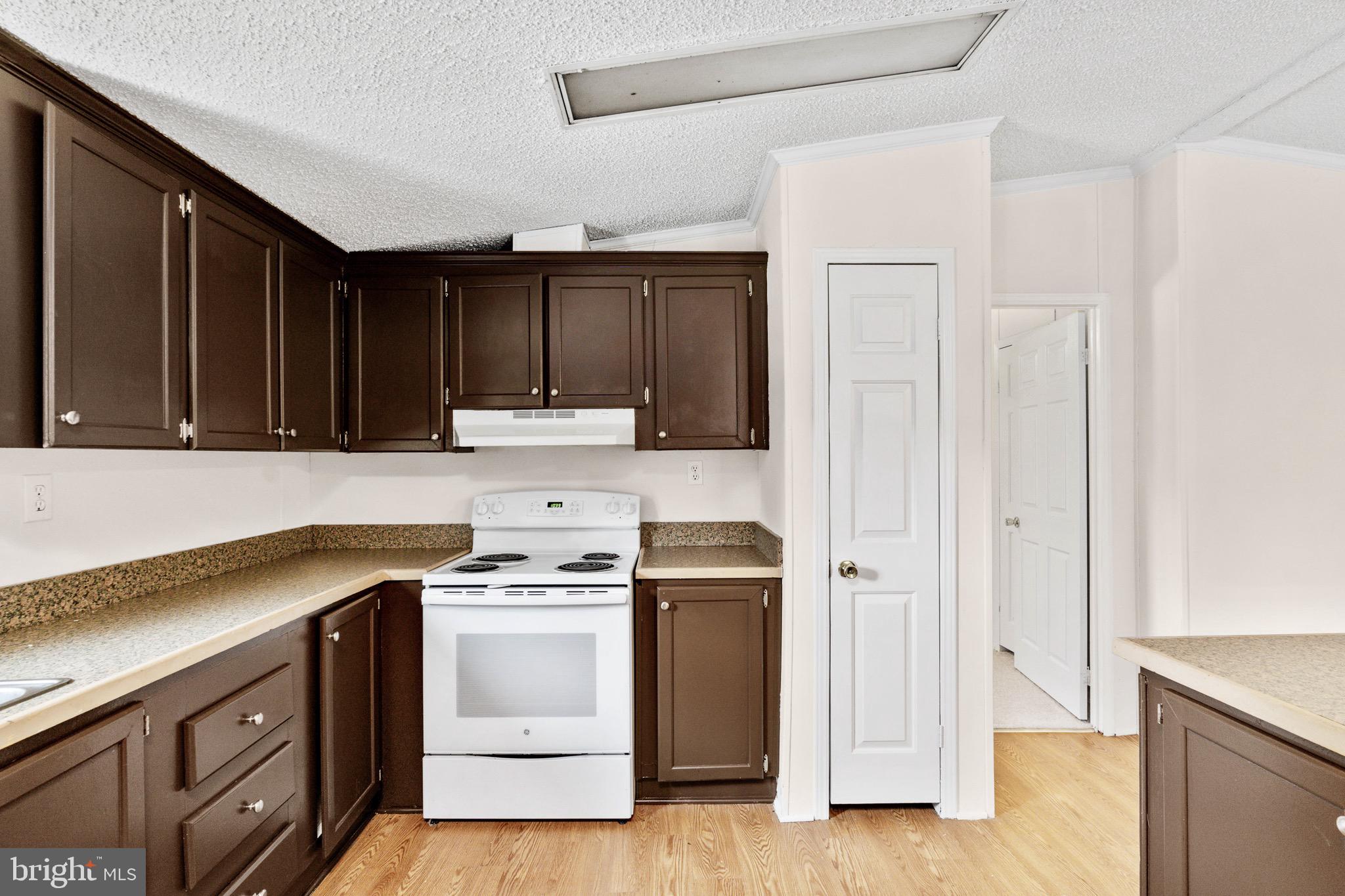 185 Deane Road Louisa, VA 23093 - Photo 24 of 42 a kitchen with wooden cabinets and a stove top oven