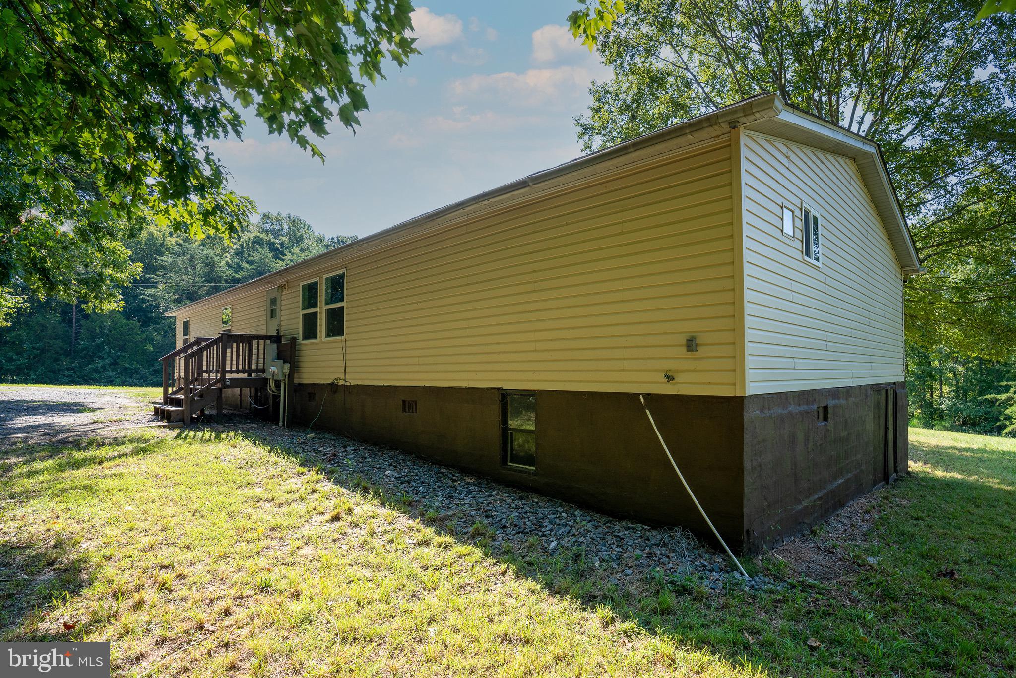 185 Deane Road Louisa, VA 23093 - Photo 4 of 42 a view of a house with backyard and a tree