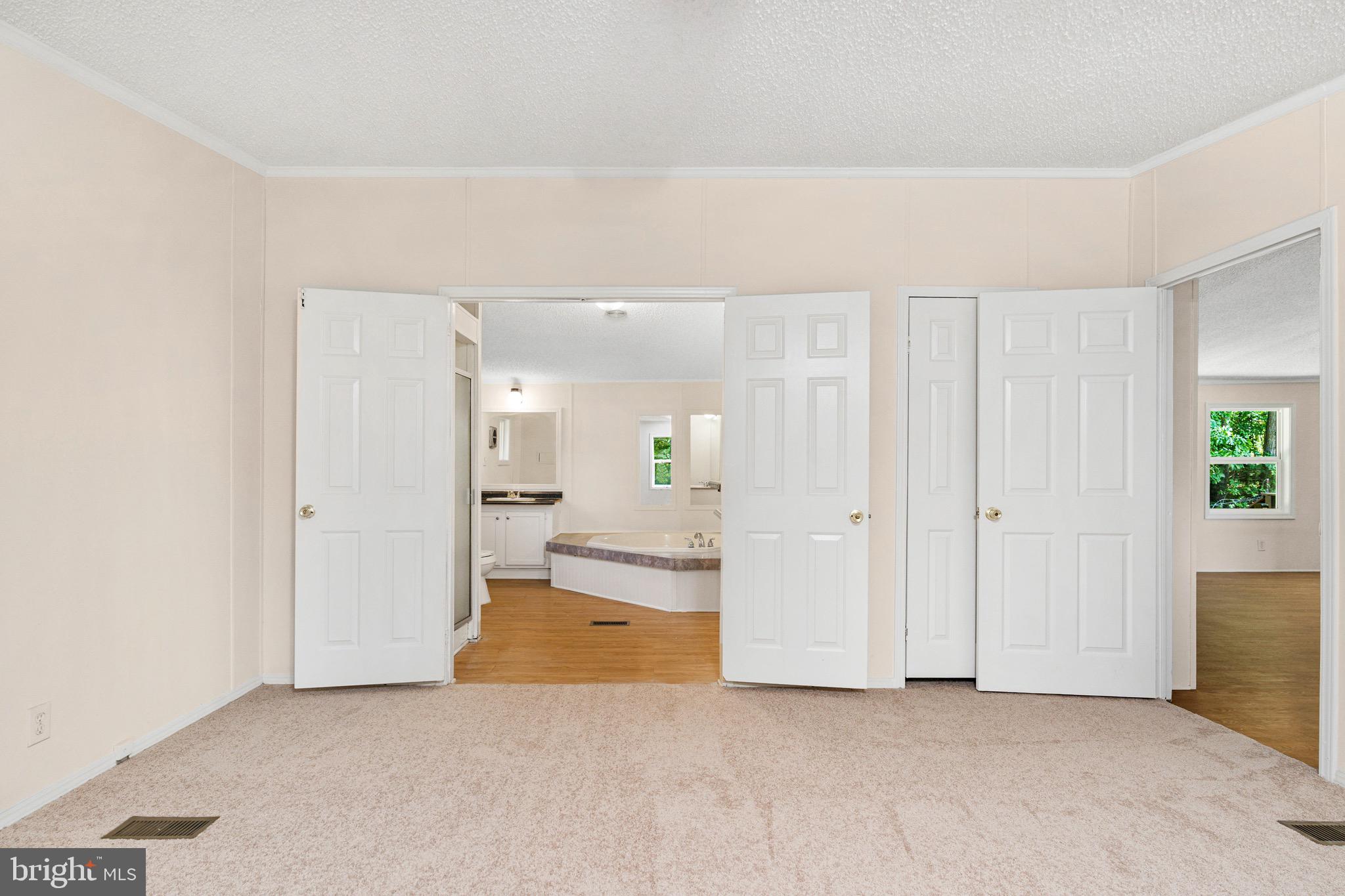 185 Deane Road Louisa, VA 23093 - Photo 36 of 42 an empty room with kitchen view and mirror