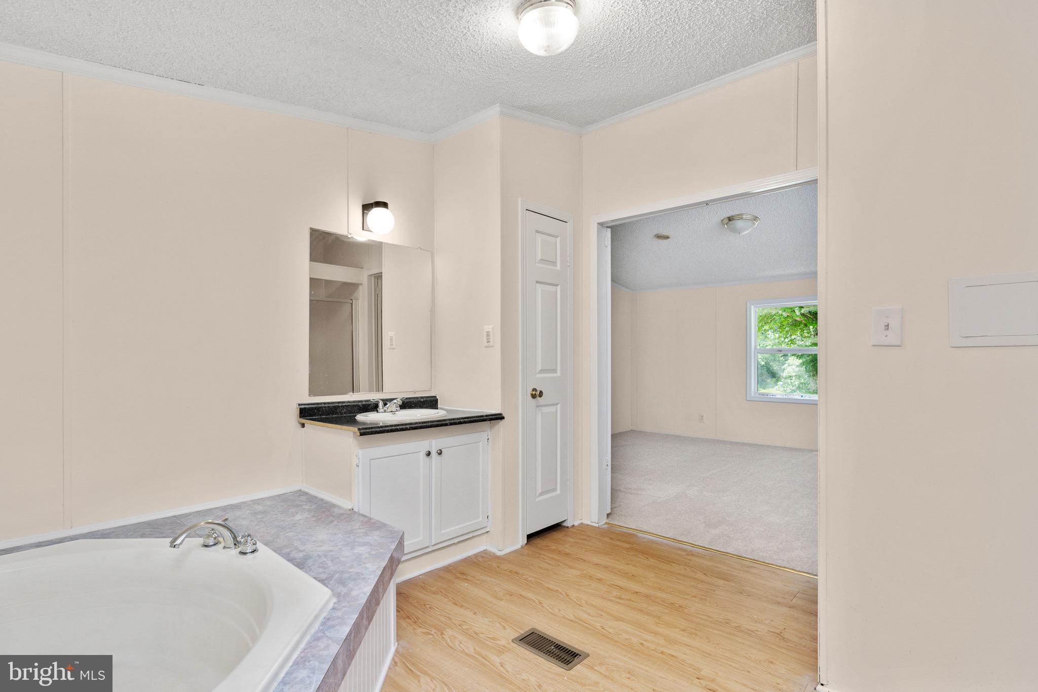 185 Deane Road Louisa, VA 23093 - Photo 39 of 42 a bathroom with a sink and a window