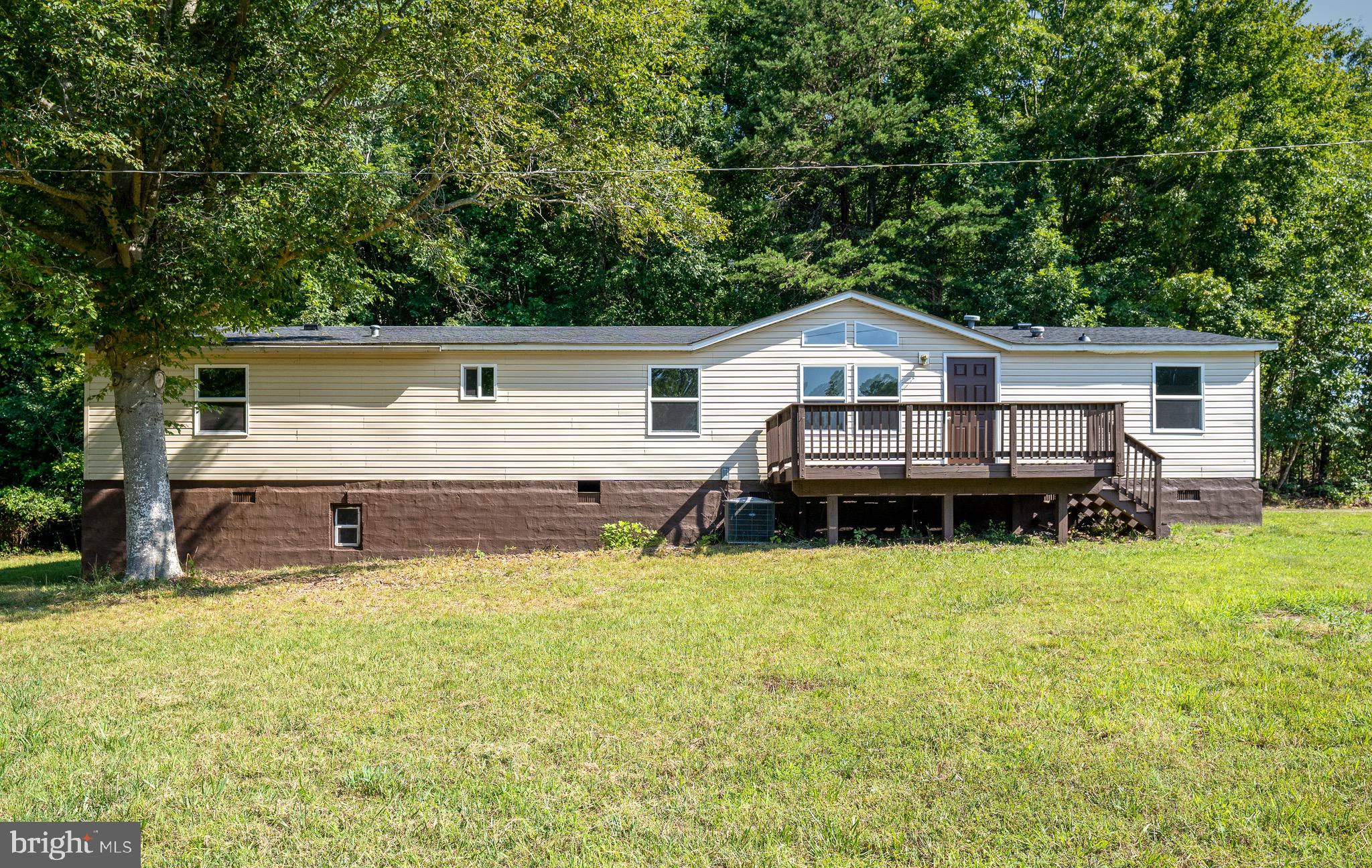 185 Deane Road Louisa, VA 23093 - Photo 5 of 42 a view of a house with a yard and sitting area