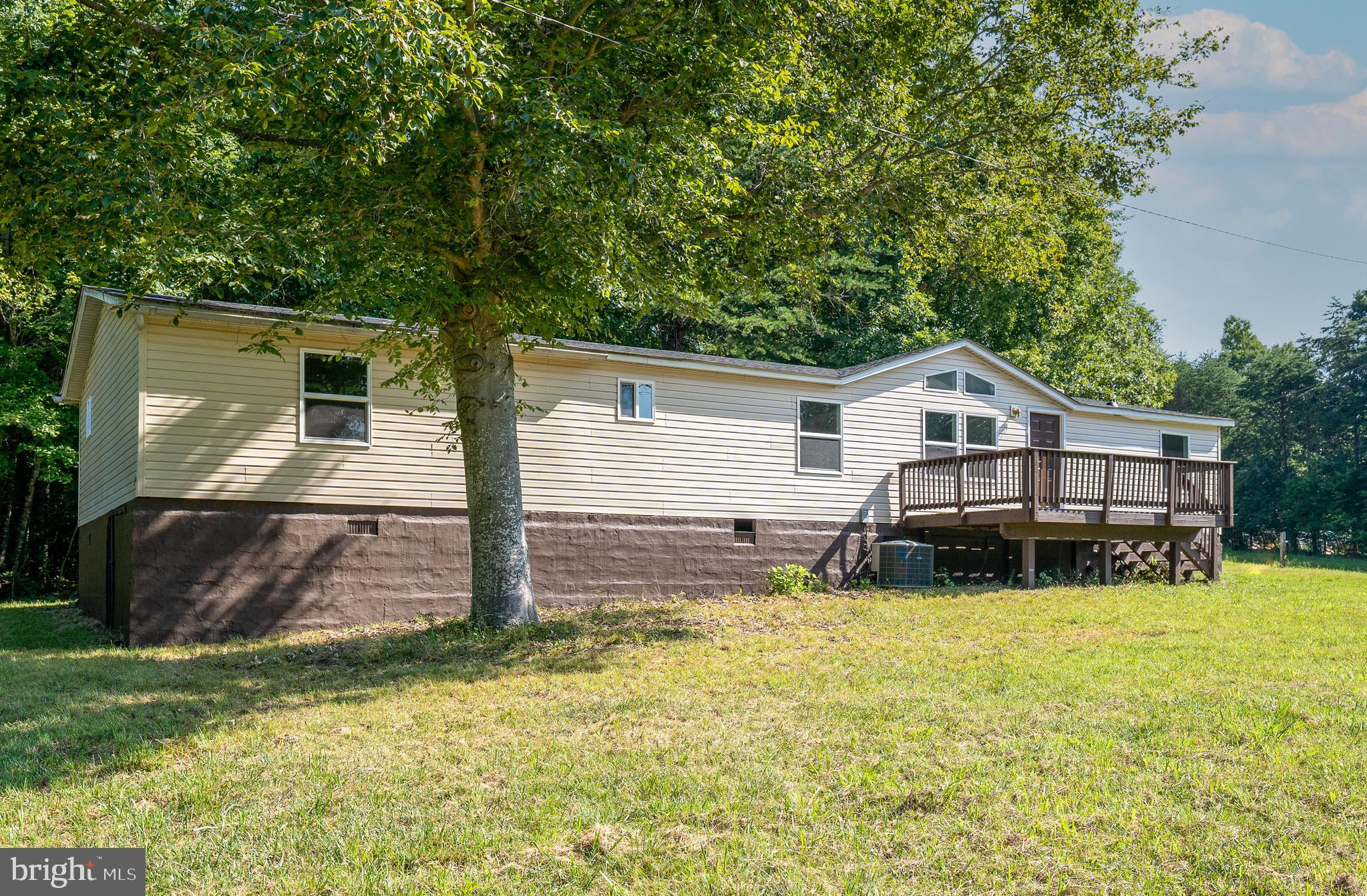 185 Deane Road Louisa, VA 23093 - Photo 6 of 42 a backyard of a house with table and chairs