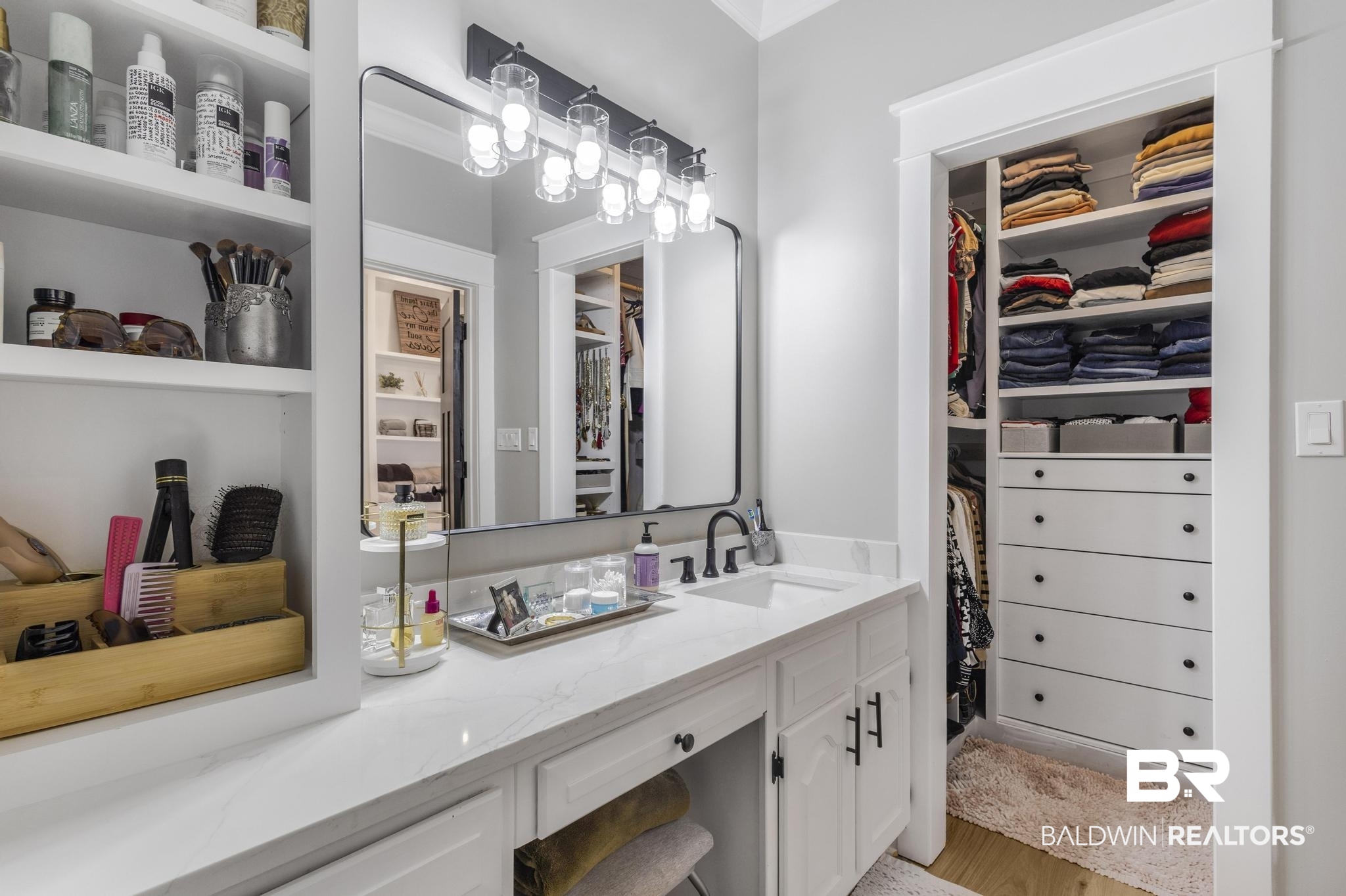 83 Caisson Trace Daphne, AL 36527 - Photo 36 of 63 Vanity area featuring a built-in dressing table with quartz countertop, undermount sink, and matte black fixtures