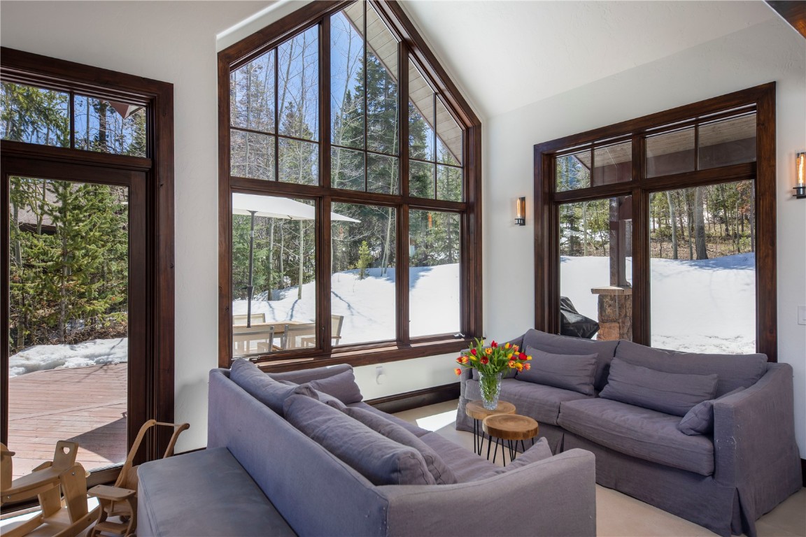 525 Two Cabins Drive Silverthorne, CO 80498 - Photo 12 of 35 a living room with furniture and floor to ceiling windows