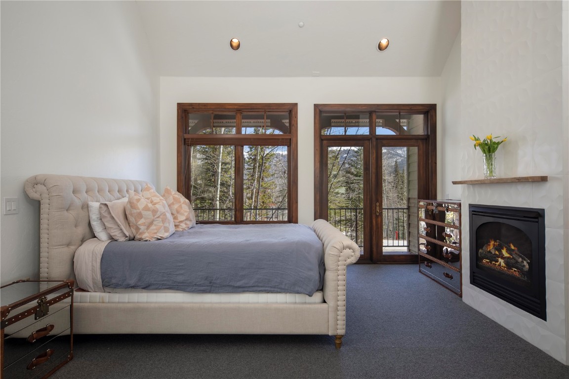 525 Two Cabins Drive Silverthorne, CO 80498 - Photo 19 of 35 a bedroom with a bed and a fireplace