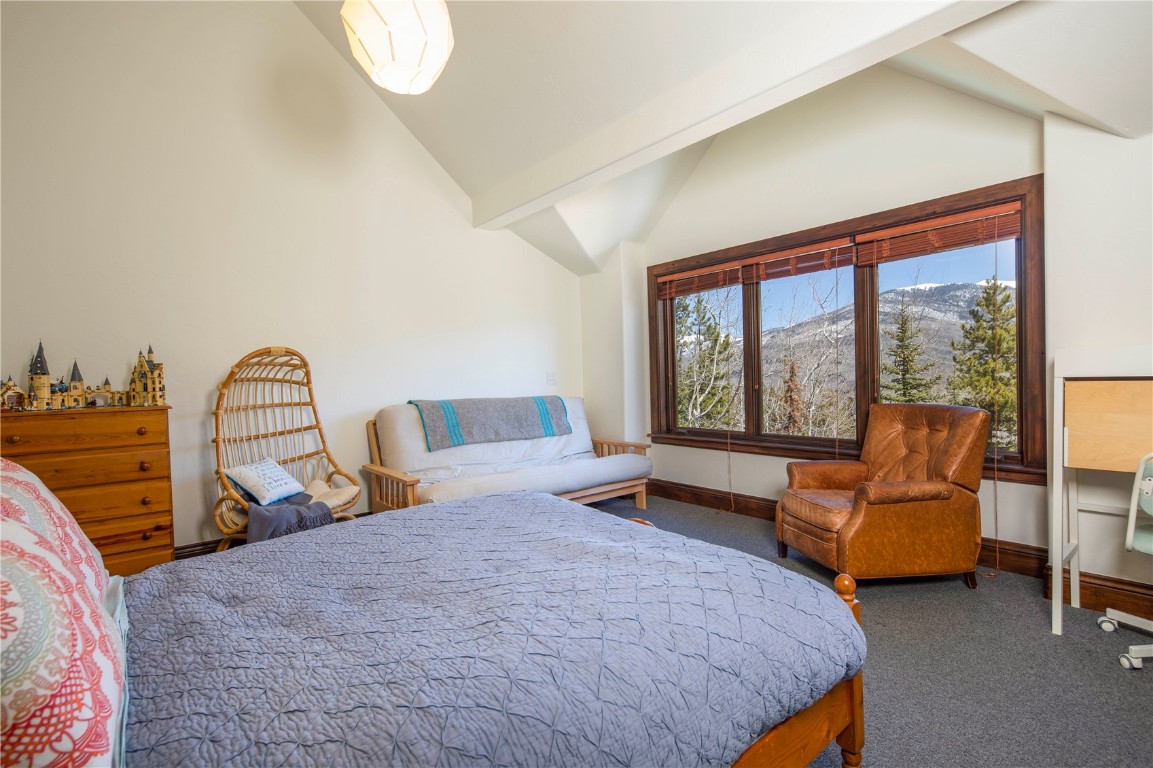 525 Two Cabins Drive Silverthorne, CO 80498 - Photo 24 of 35 a bedroom with a bed and a large window