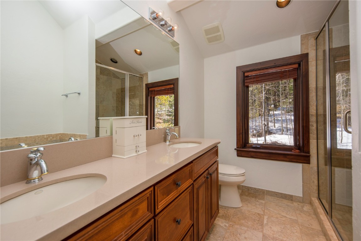525 Two Cabins Drive Silverthorne, CO 80498 - Photo 25 of 35 a bathroom with a granite countertop sink mirror and toilet