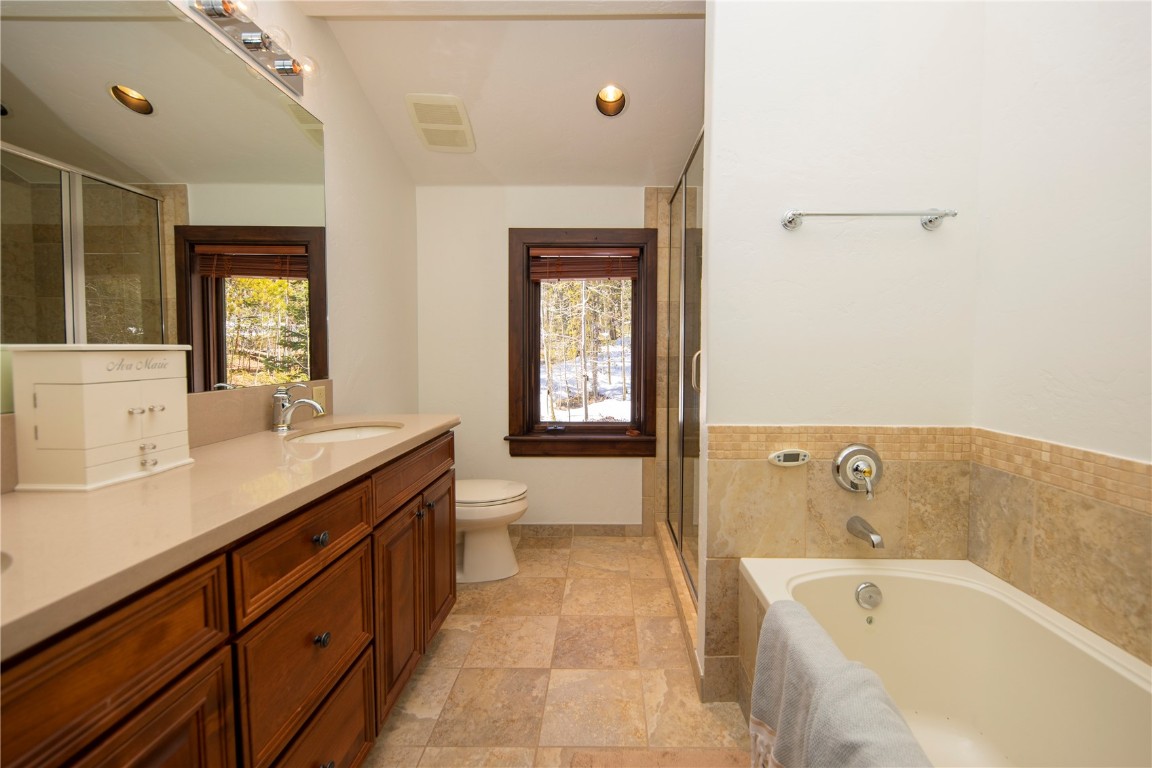 525 Two Cabins Drive Silverthorne, CO 80498 - Photo 26 of 35 a spacious bathroom with a tub sink and mirror
