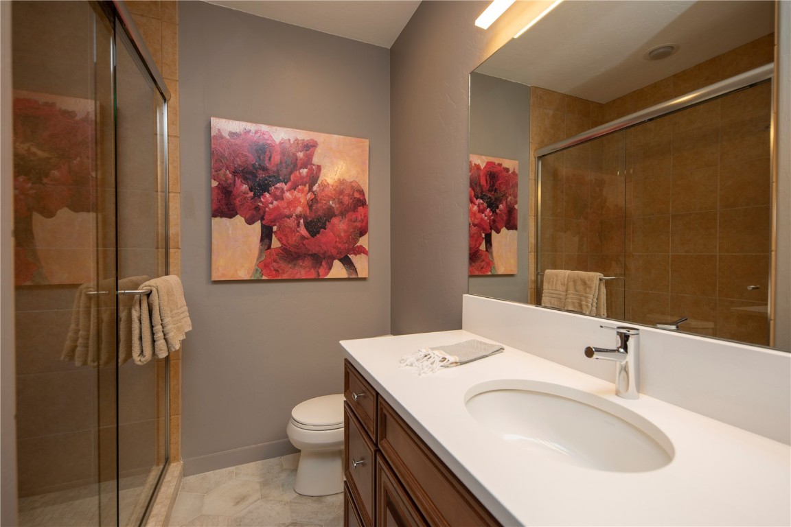 525 Two Cabins Drive Silverthorne, CO 80498 - Photo 31 of 35 a bathroom with a sink a toilet and shower