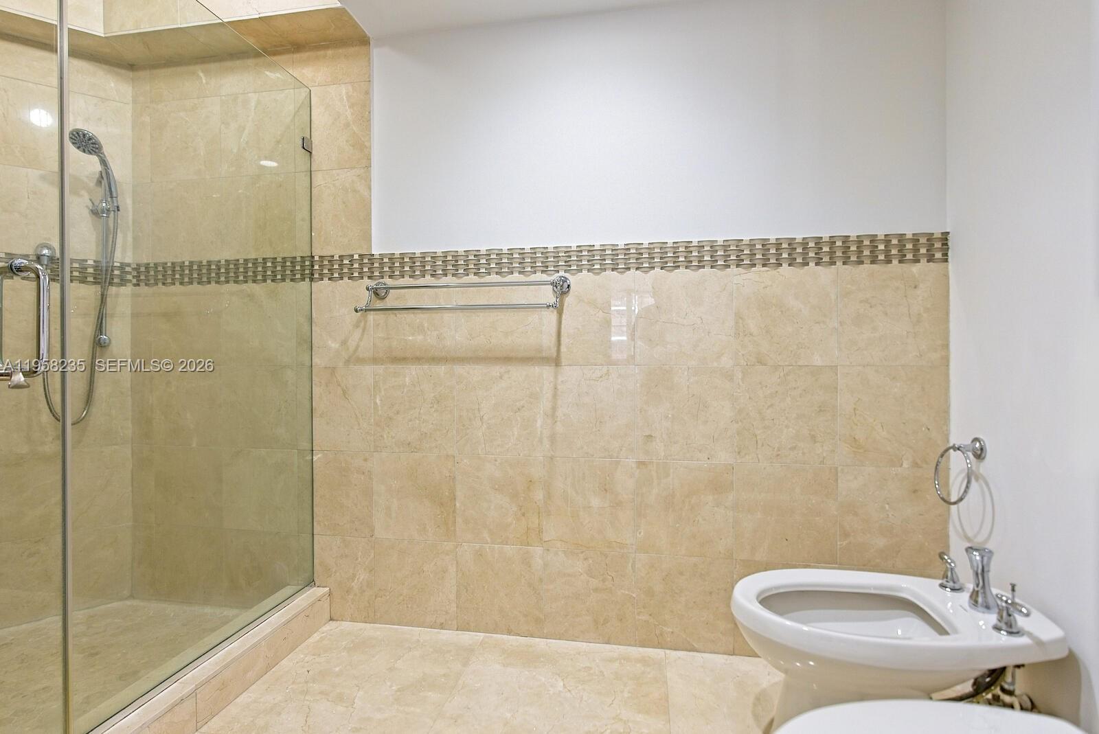 1925 Brickell Avenue, Unit D1201 Miami, FL 33129 - Photo 11 of 27 a bathroom with a shower a toilet and a sink