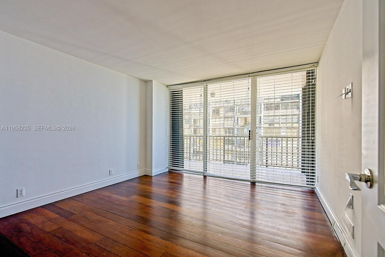 1925 Brickell Avenue, Unit D1201 Miami, FL 33129 - Photo 13 of 27 wooden floor in an empty room with a window