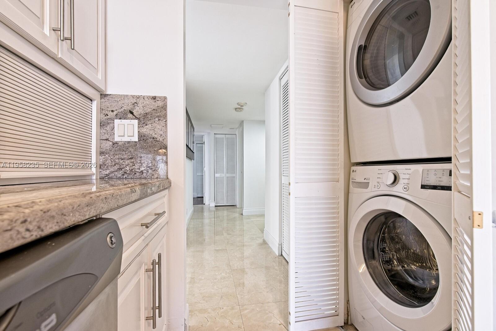 1925 Brickell Avenue, Unit D1201 Miami, FL 33129 - Photo 16 of 27 a utility room with dryer and washer