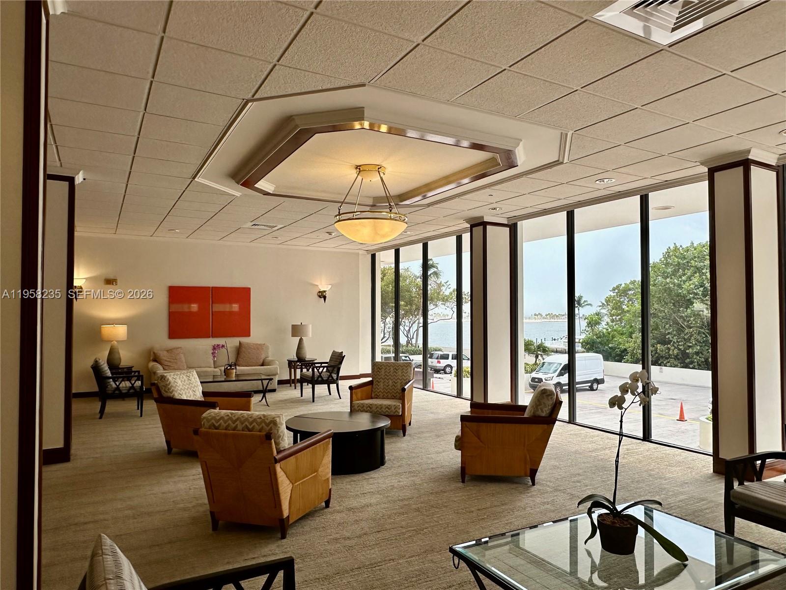 1925 Brickell Avenue, Unit D1201 Miami, FL 33129 - Photo 21 of 27 a living room with patio furniture and a large window