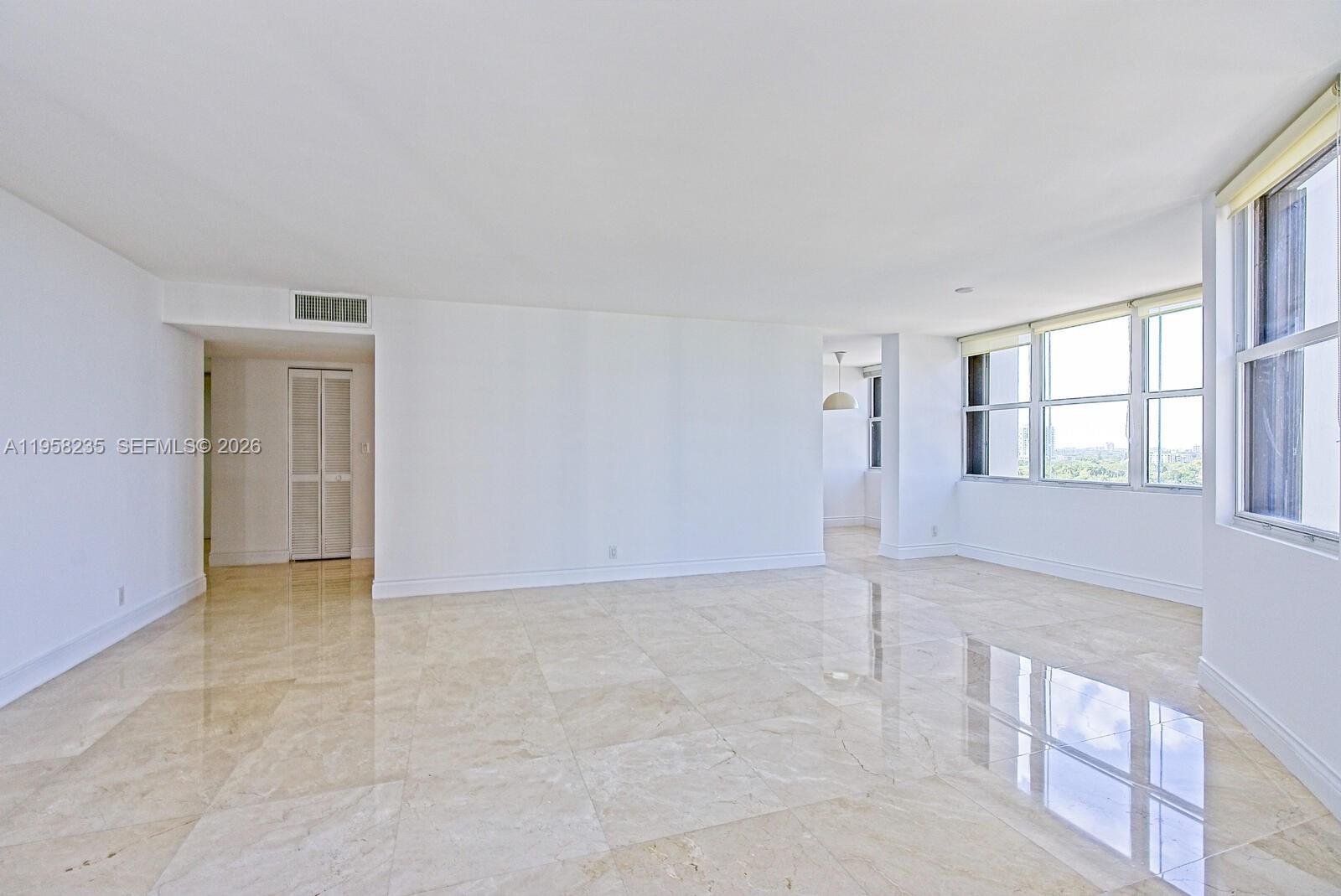 1925 Brickell Avenue, Unit D1201 Miami, FL 33129 - Photo 5 of 27 an empty room with windows and closet