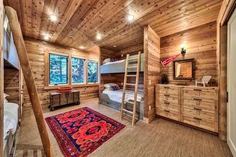 a view of a bedroom with furniture and window