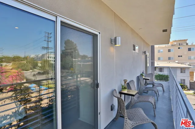 a view of a hallway with furniture and front door