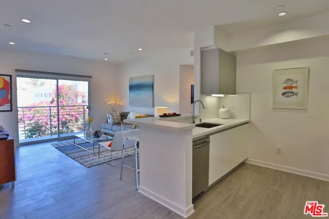 a living room with kitchen island furniture and a wooden floor