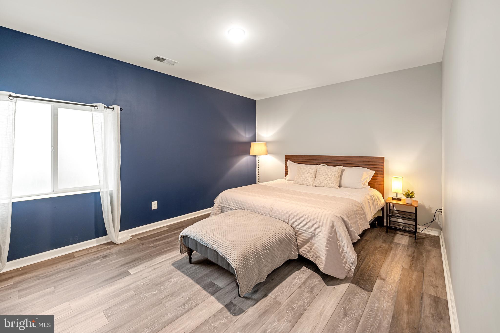 8459 Reformatory Way Lorton, VA 22079 - Photo 50 of 78 a bedroom with a bed and wooden floor