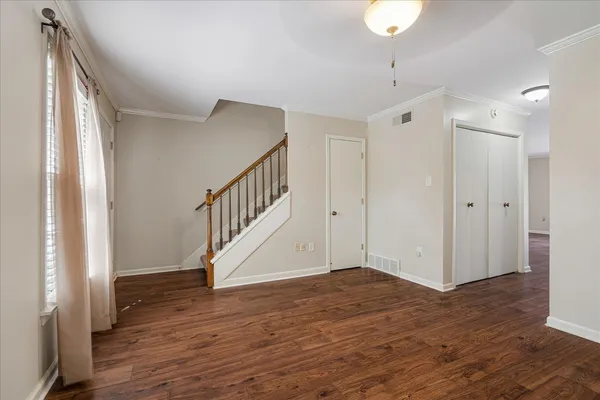 wooden floor in an empty room with a window