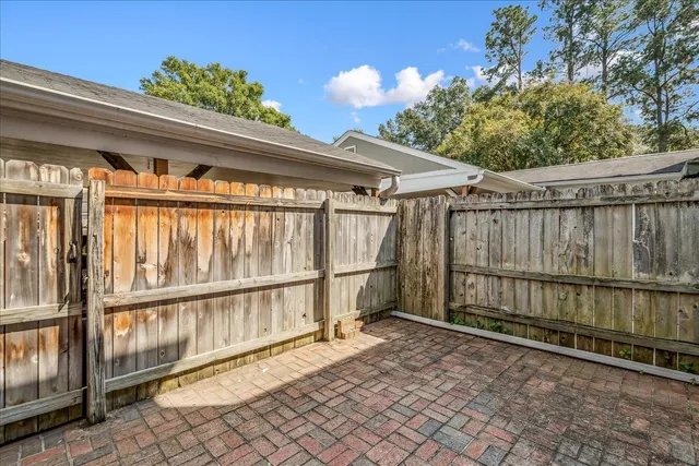 a view of a garage with wooden fence