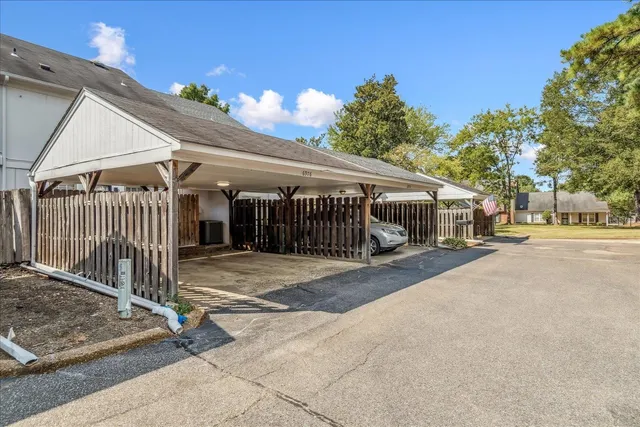 a view of a yard with a house and large trees
