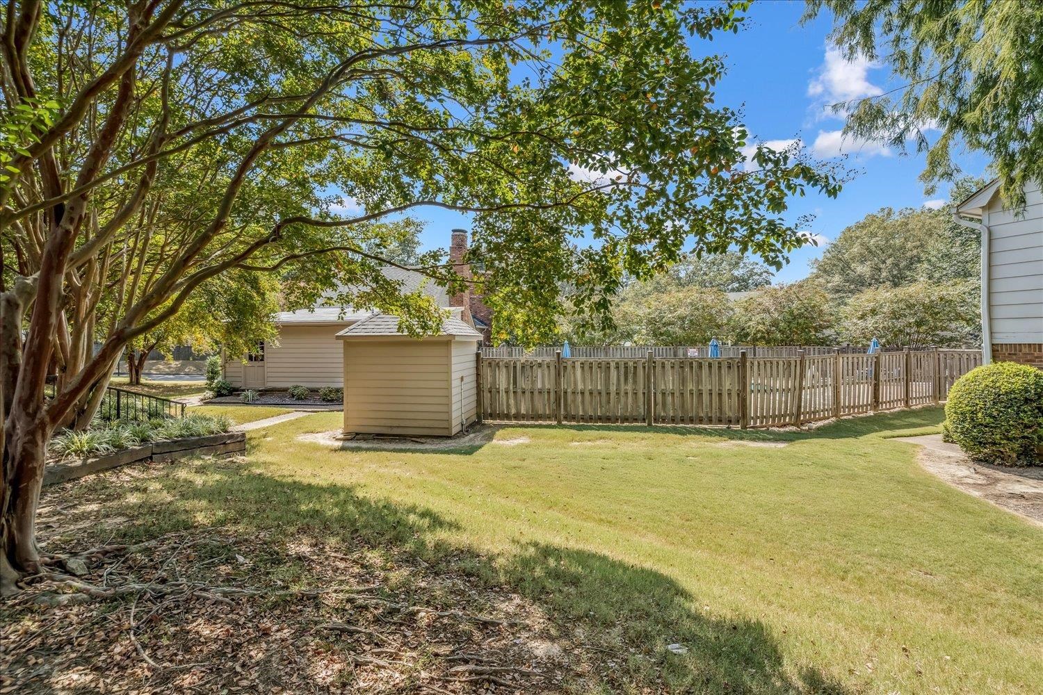 6976 Country Road, Unit 34 Germantown, TN 38138 - Photo 23 of 25 a view of a yard with a house and large trees